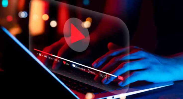 online-movie-streaming-with-laptop-computer-young-man-watching-a-movie-on-a-mobile-phone-with