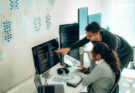 hispanic-programmers-collaborating-on-software-development-in-a-modern-office-setting
