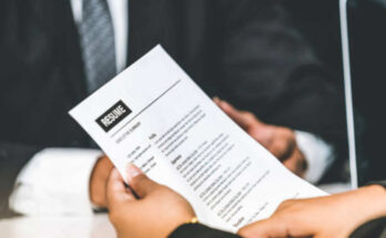 human-resources-department-manager-reads-cv-resume-document-of-an-employee-candidate-at