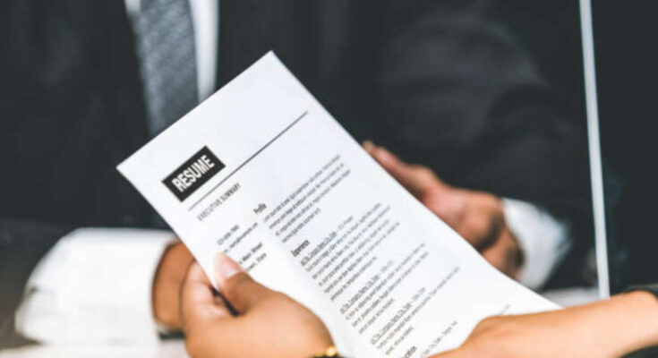 human-resources-department-manager-reads-cv-resume-document-of-an-employee-candidate-at