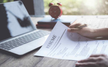 business-man-review-his-resume-application-on-desk-laptop-computer-job-seeker