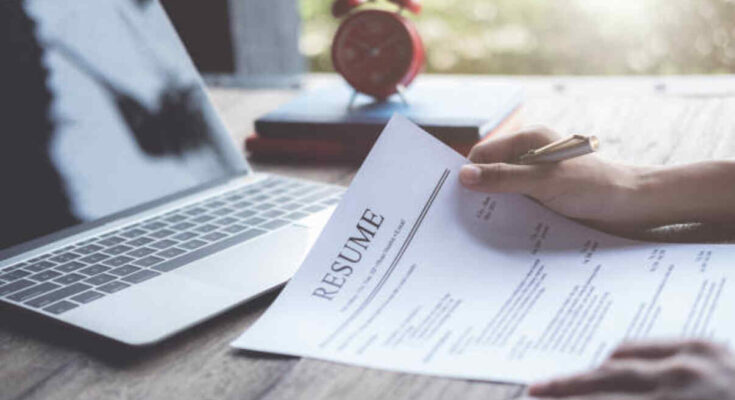 business-man-review-his-resume-application-on-desk-laptop-computer-job-seeker